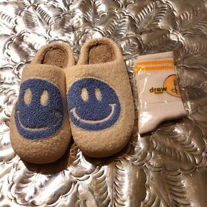 A set of house shoes,brand new,and a pair of socks! So plush!;smiley/ drew house